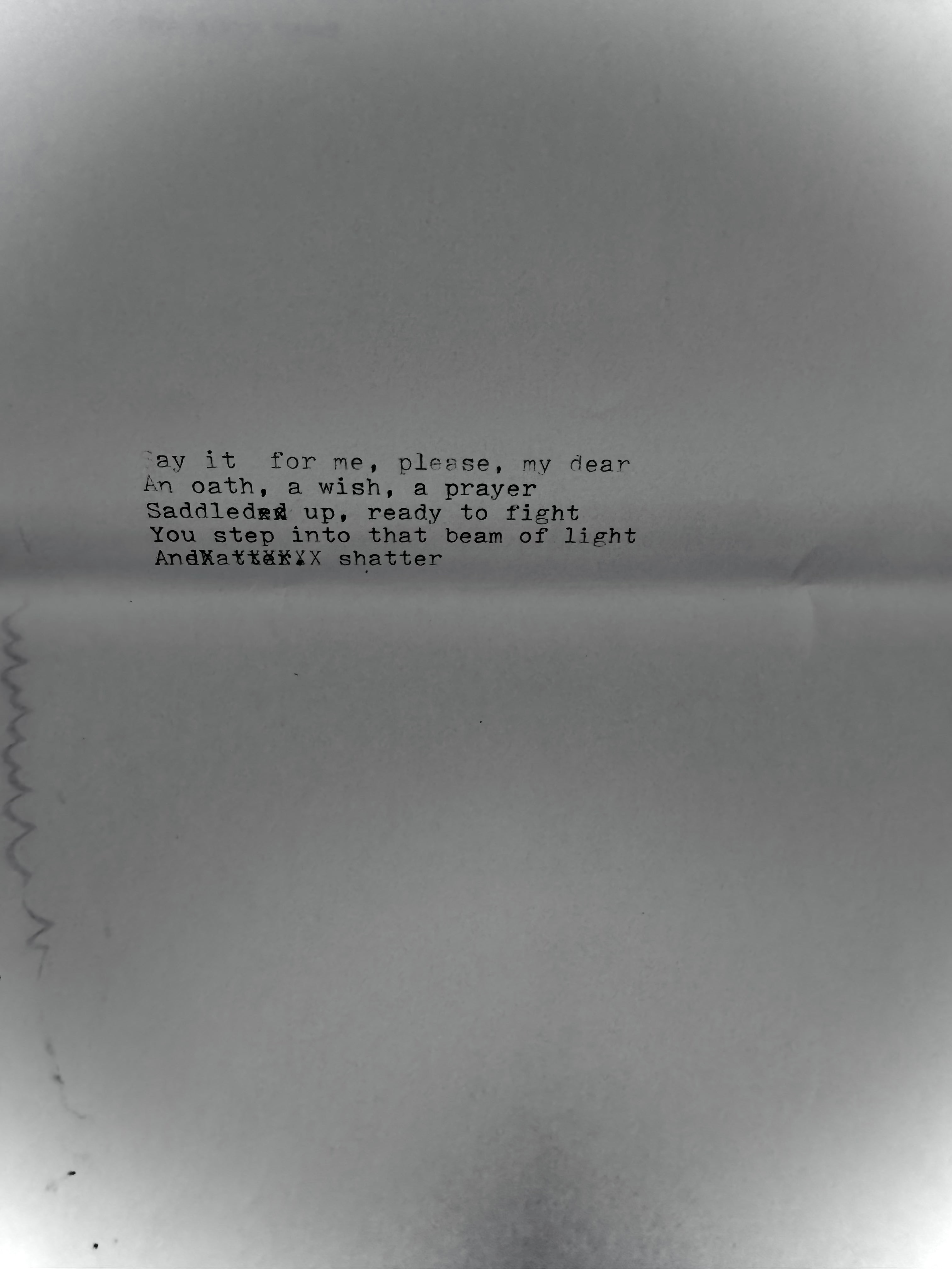 A square white card with black printed text, photographed. Reads, 'Say it for me, please, my dear / An oath, a wish, a prayer / Saddled up ready to fight / You step into that beam of light / And shatter